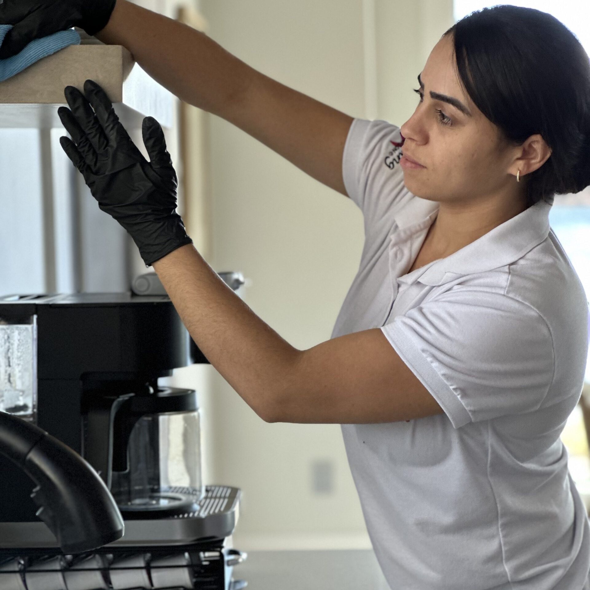 Professional home cleaning specialist from Simplify Cleaning Services performing detailed residential maintenance in a Massachusetts home.