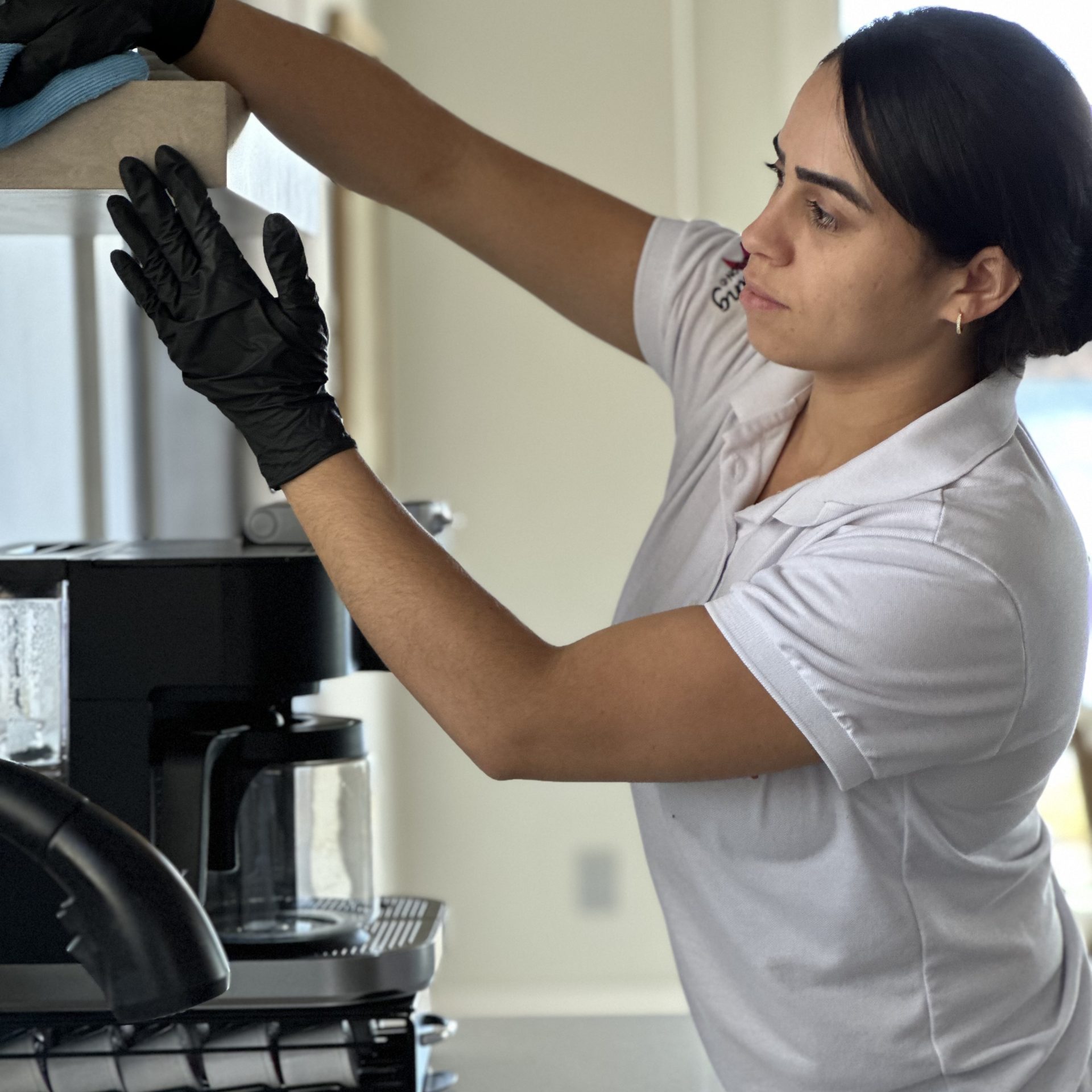 Professional home cleaning specialist from Simplify Cleaning Services performing detailed residential maintenance in a Massachusetts home.